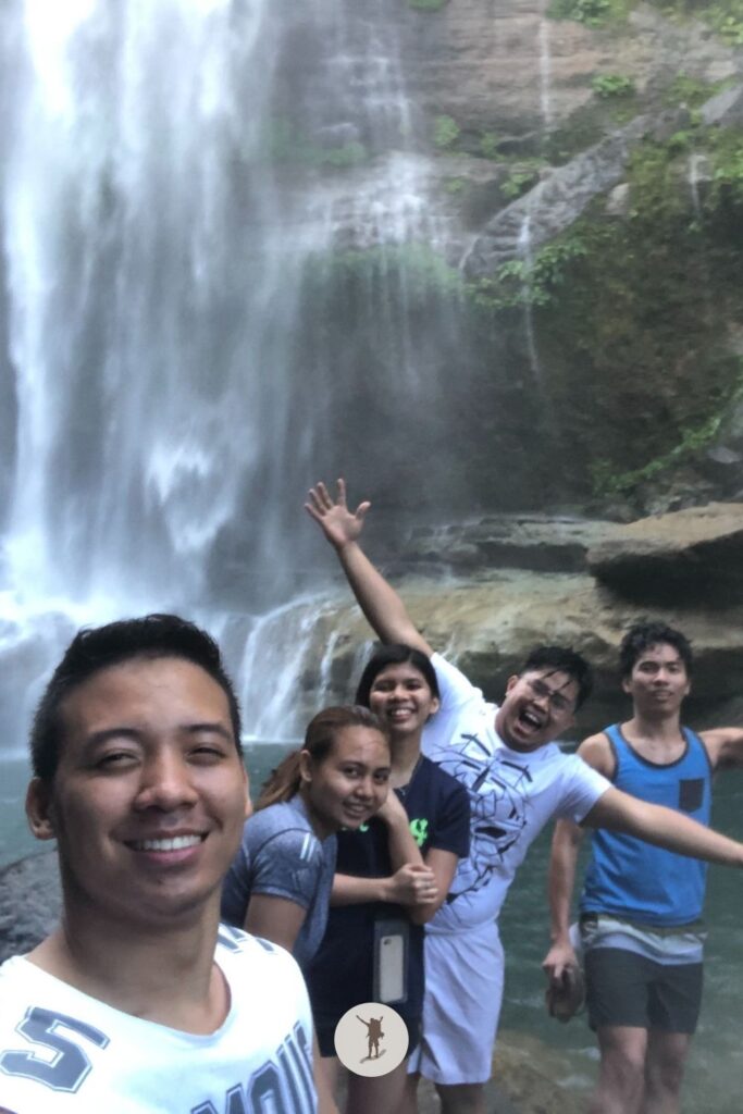 Smiling yet we're chattering because it is too cold at Bomod-Ok Falls plunge pool in Sagada, Philippines