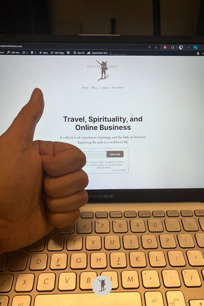 My laptop screen is displaying the homepage of Explore to Thrive