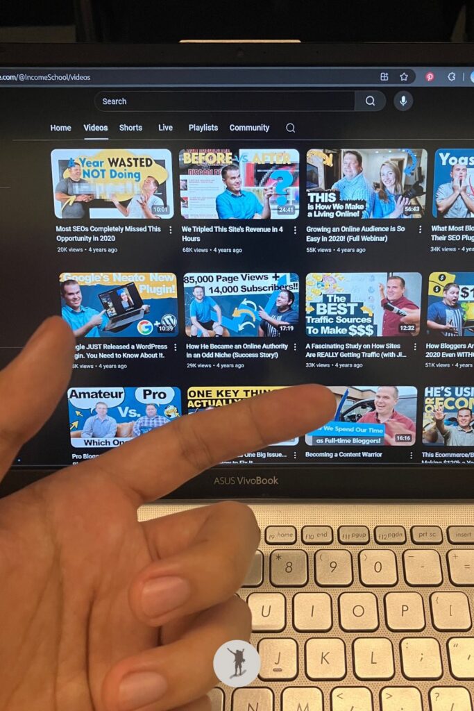 The YouTube videos from Income School are displayed on my laptop screen