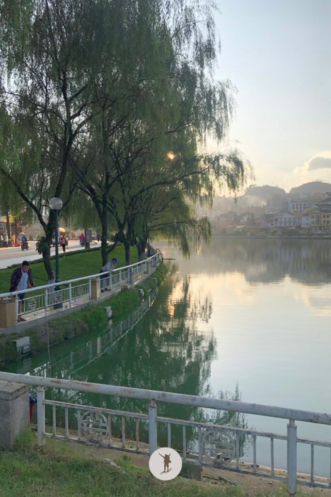 Guy fishing over the calm surface of Lake Sa Pa, Vietnam