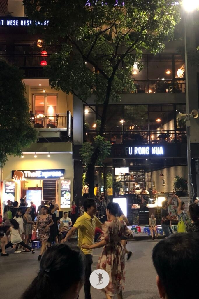 People dancing in the middle of the street, during Hanoi Walking Street, Hanoi, Vietnam