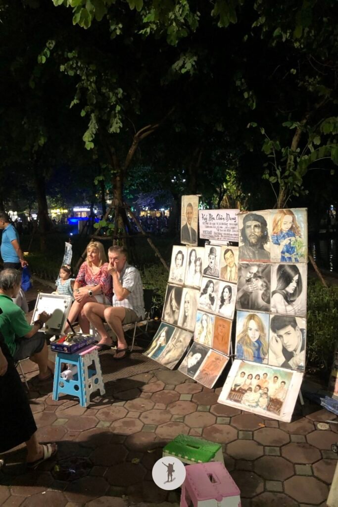 Artist sketching the tourists during Hanoi Walking Street, Hanoi, Vietnam