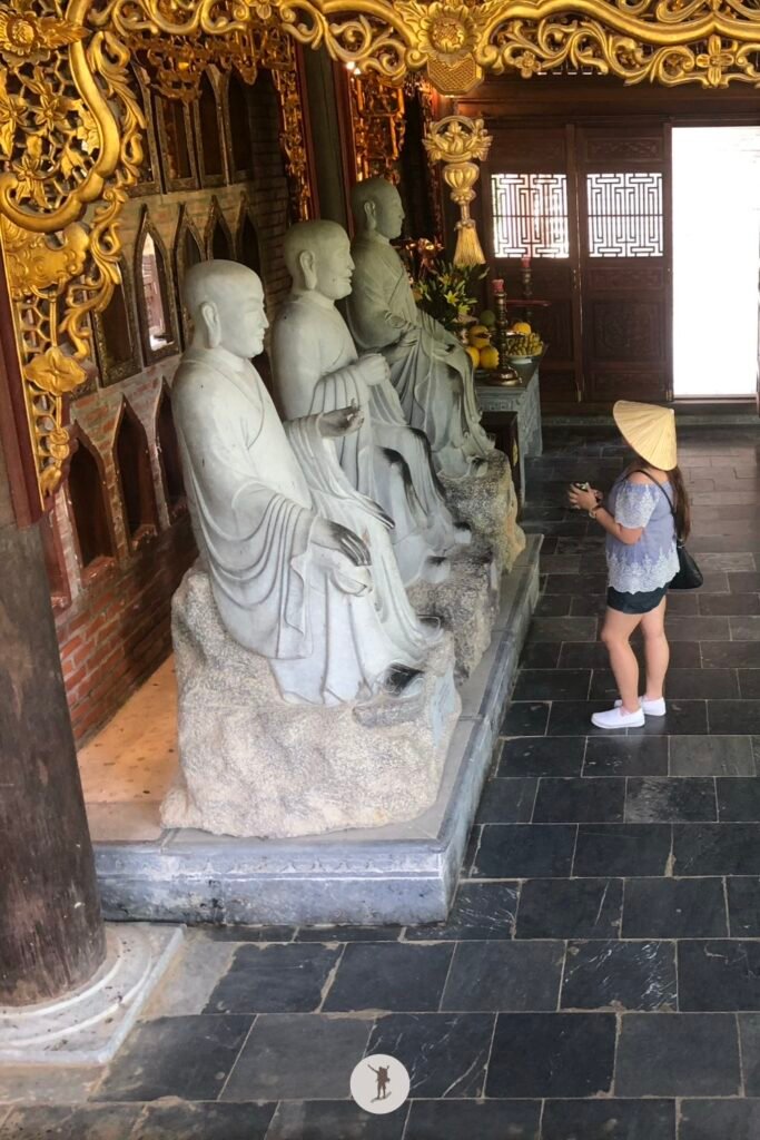 My friend checking the details of the statues in the pathway in Bai Dinh Pagoda, Ninh Binh, Vietnam