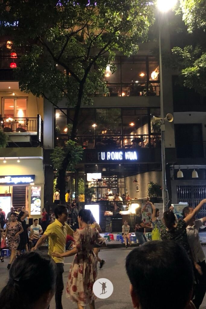 Senior citizen dancing during Hanoi Walking Street, Hanoi, Vietnam