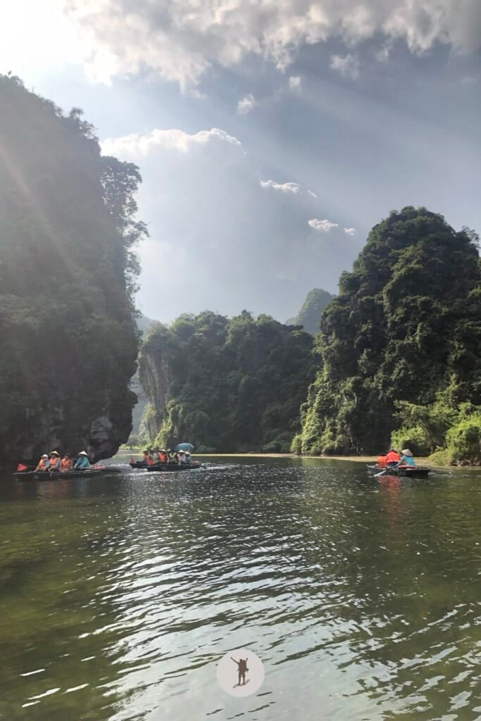 Sun peaking behind the spectacular karst in Trang An, Ninh Binh, Vietnam