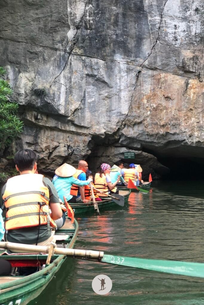 Tourist entering the underground river in Trang An, Ninh Binh, Vietnam
