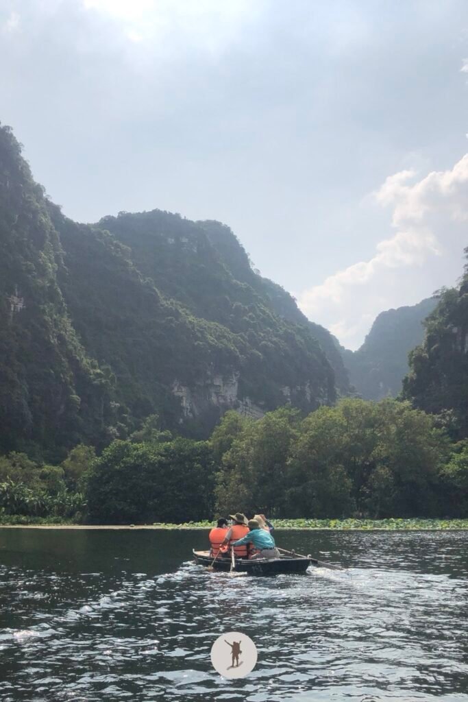Us following the trail of another boat in Trang An, Ninh Binh, Vietnam