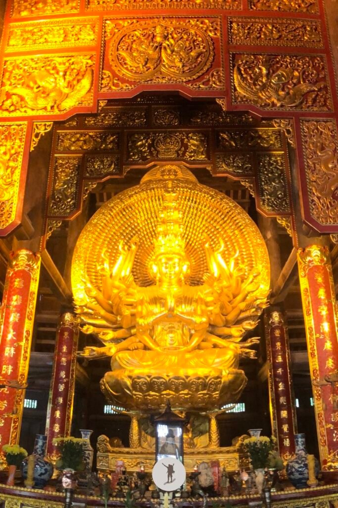 A marvelous golden statue of Buddha inside a temple in Bai Dinh Pagoda, a tourist attraction to visit during a day trip to Ninh Binh from Hanoi, Vietnam