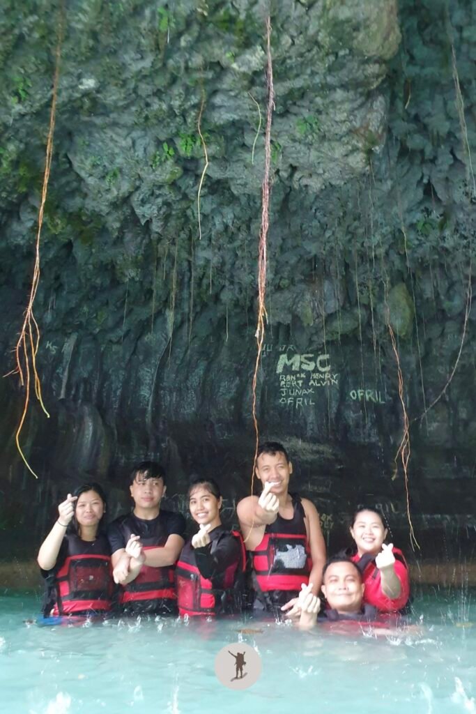 Finger heart pose inside or under Kawasan Falls after canyoneering, Cebu, Philippines