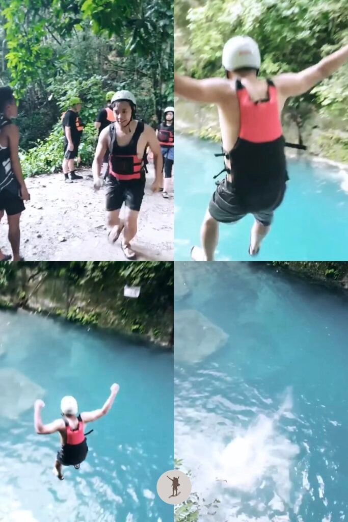 Jumping off the cliff into the turquoise waters while canyoneering in Kawasan Falls, Badian, Cebu, Philippines