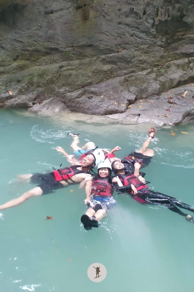 Our group happily gliding on the water in while on a star position during canyoneering in Kawasan Falls, Cebu, Philippines
