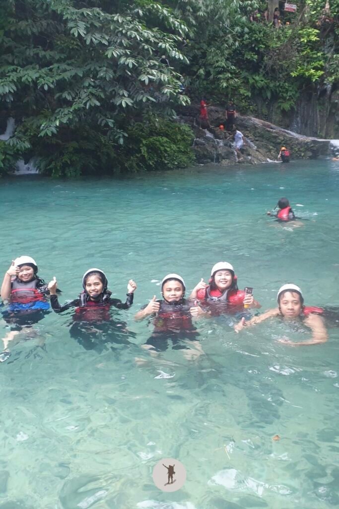 Swimming after taking the long slide in Kawasan Falls canyoneering, Cebu, Philippines