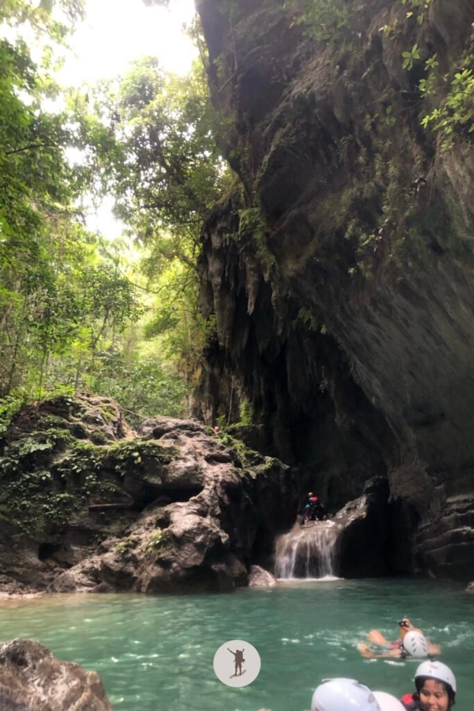 View of the cave with visible stalactites from the water along the trail of Kawasan Falls Canyoneering, Cebu, Philippines