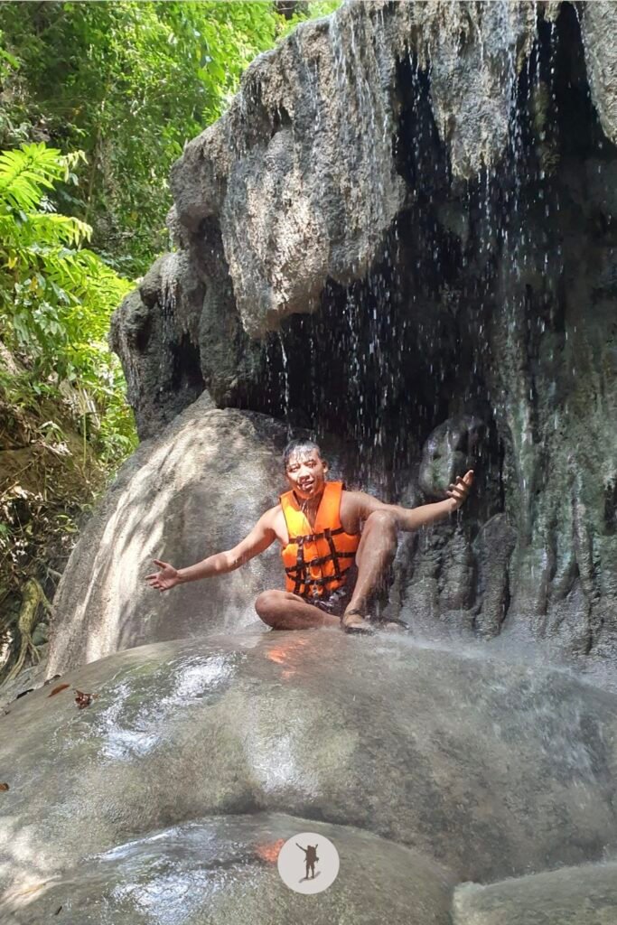 A photo of me feeling the drops of water falling on me at Aguinid Falls, Cebu, Philippines