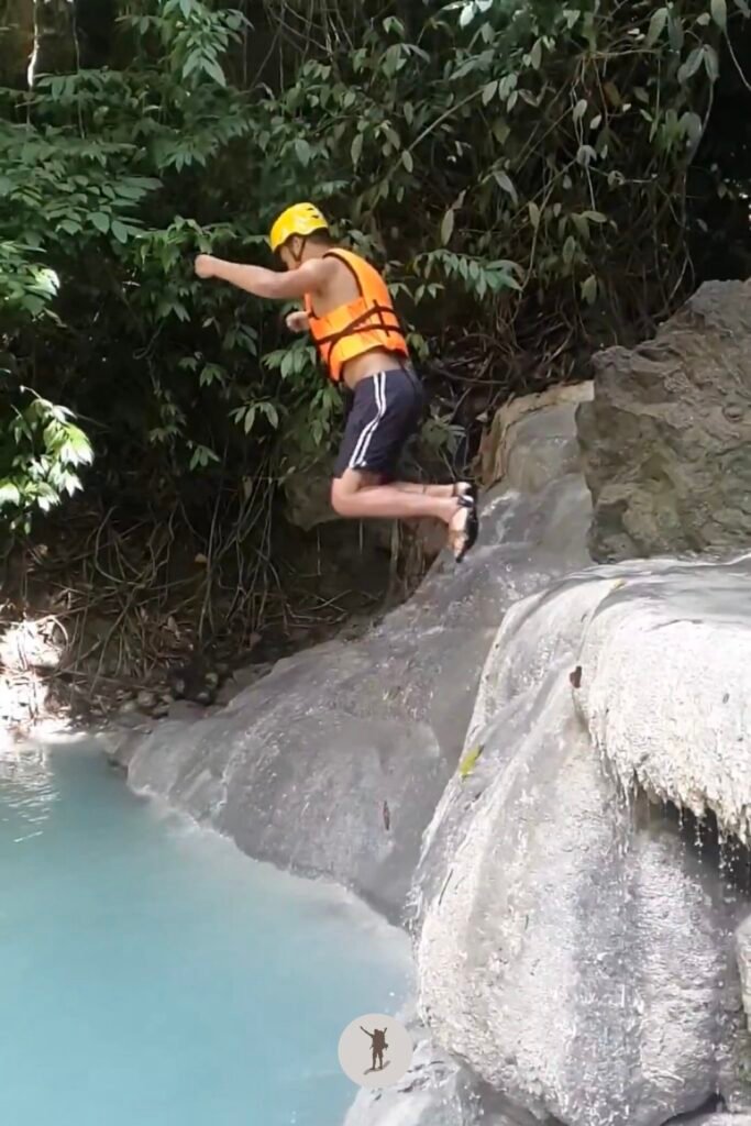 A photo of me having jumped from a 2-meter boulder into the water at Aguinid Falls, Cebu, Philippines