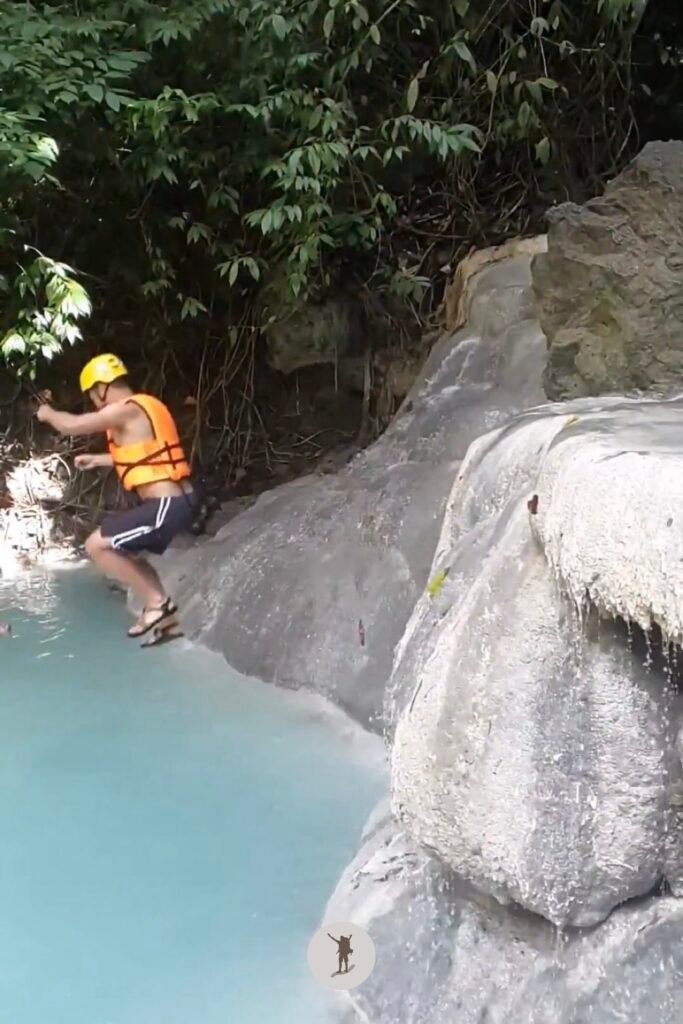 A photo of me mid-air after jumping from a 2-meter boulder into the water at Aguinid Falls, Cebu, Philippines