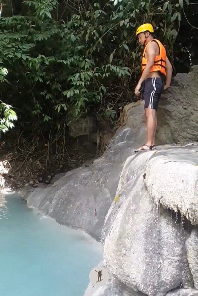 A photo of me ready to jump from a 2-meter boulder into the water at Aguinid Falls, Cebu, Philippines