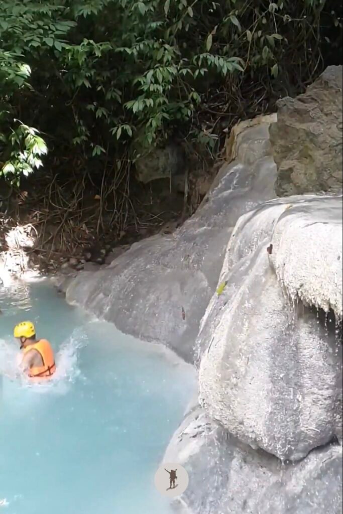A photo of me touching the water after jumping from a 2-meter boulder at Aguinid Falls, Cebu, Philippines