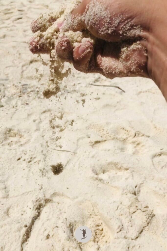 Our Beautiful Experience Visiting Sumilon Island After Whale Shark Watching in Oslob 21 A picture of my hand gently pouring the sand to the ground in Sumilon Island, Oslob, Cebu, Philippines