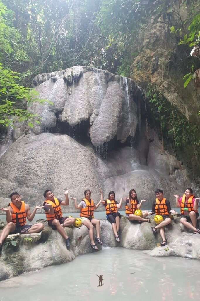 A random wacky pose suggested by the guide while in front of the main falls of Aguinid Falls, Cebu, Philippines