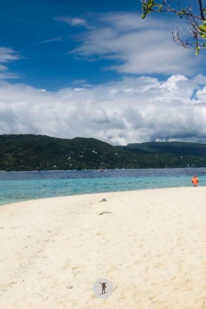 Our Beautiful Experience Visiting Sumilon Island After Whale Shark Watching in Oslob 19 A tourist walking alone in the paradise looking beach of Sumilon Island, Oslob, Cebu, Philippines