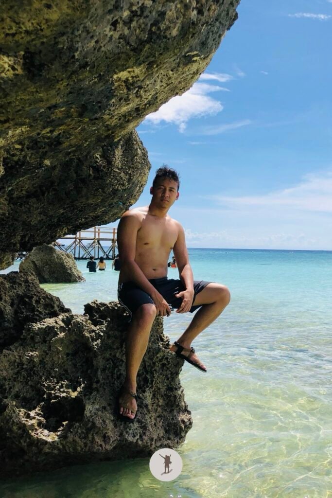 Our Beautiful Experience Visiting Sumilon Island After Whale Shark Watching in Oslob 27 Me sitting at the rocks near the grottoes of Sumilon Island, Oslob, Cebu, Philippines