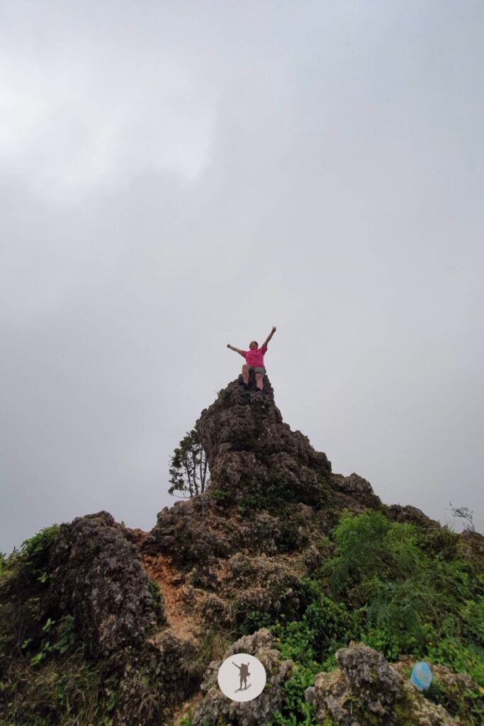 Our Expectation vs. Reality Hiking Osmeña Peak in Cebu and Tips Before You Hike 13 My friend climbing a unique rock formation at Osmena Peak, Cebu, Philippines