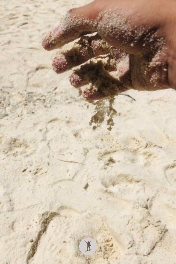 Our Beautiful Experience Visiting Sumilon Island After Whale Shark Watching in Oslob 22 My hand as I pour down the last bits of sand to the ground in Sumilon Island, Oslob, Cebu, Philippines