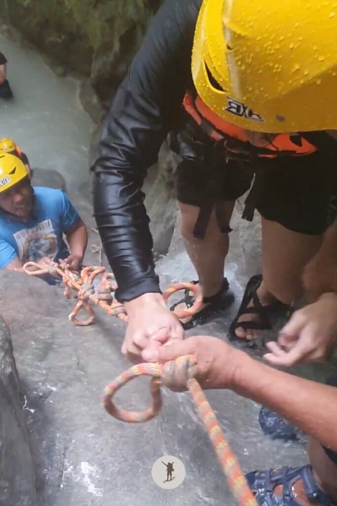My mate firmly holding the rope as he ascended to the top of the steep cascade at Aguinid Falls, Cebu, Philippines