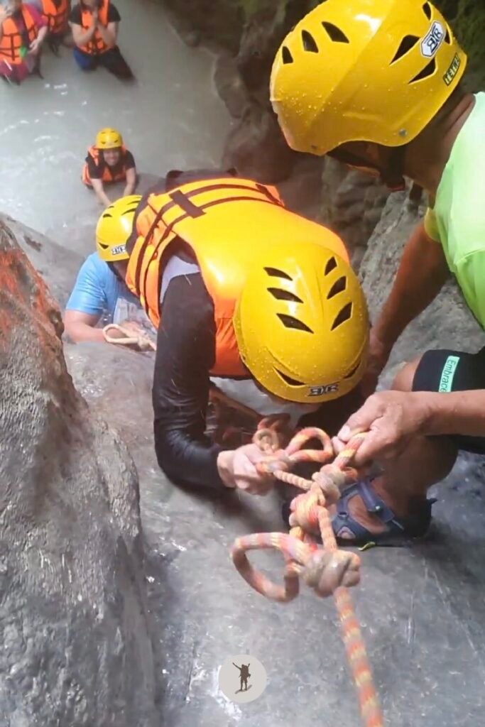 My mate scrambling to get to the top of a steep cascade at Aguinid Falls, Cebu, Philippines