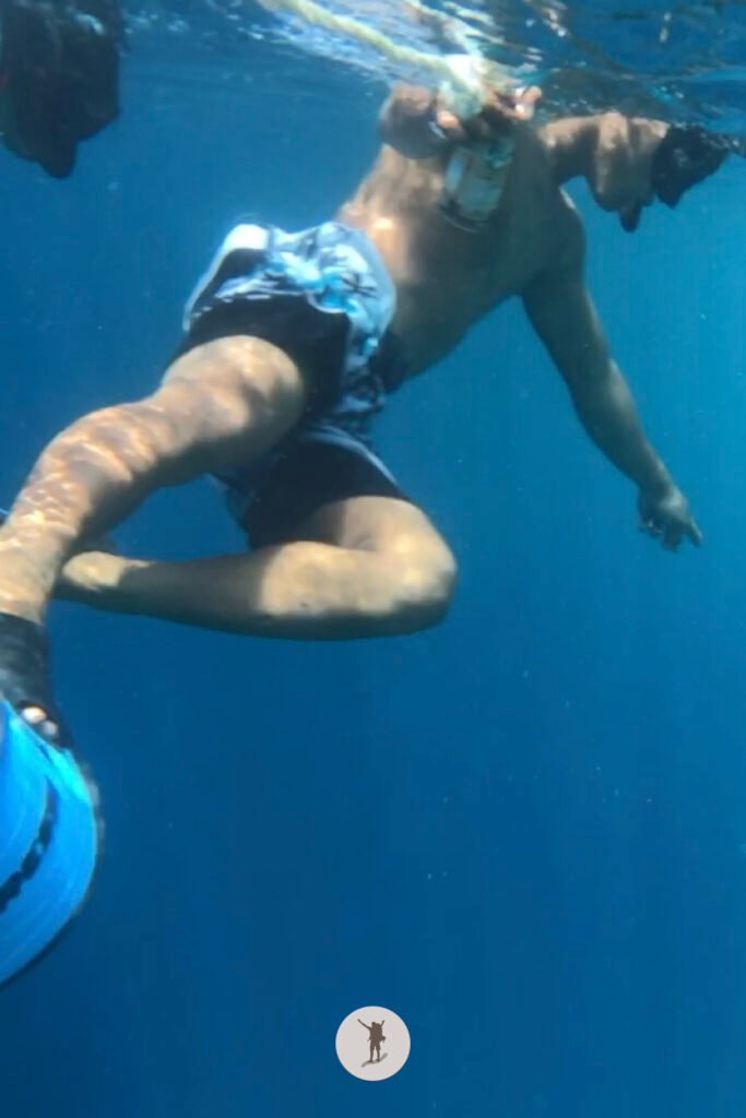 Our guide pointing the location of the sea turtle as he pull our lifebuoy during our snorkeling tour in Moalboal, Cebu, Philippines