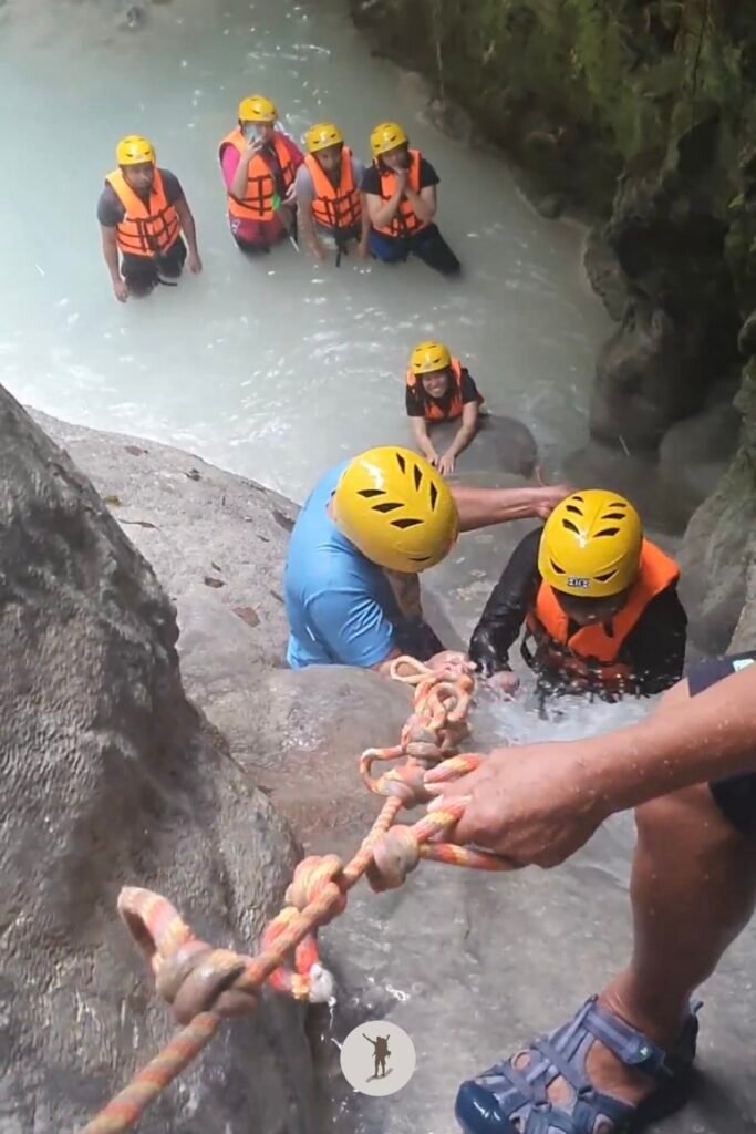 Our guide pulling the rope so my mate could easily grab it as he climbed a cascade in Aguinid Falls, Cebu, Philippines