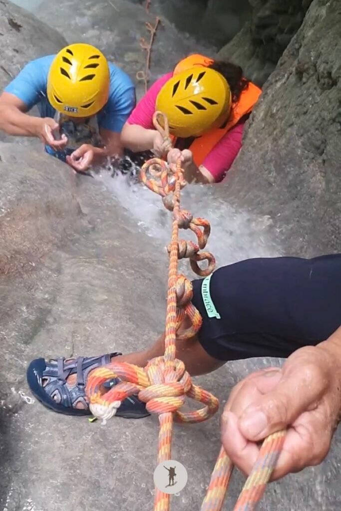 Our guide teaching our friend the technique to easily ascend the cascades at Aguinid Falls, Cebu, Philippines