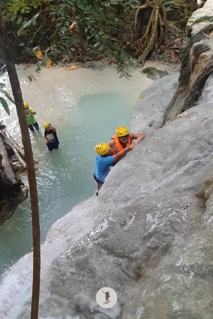 Part 1, a photo of me climbing a near-vertical rock formation at Aguinid Falls, Cebu, Philippines