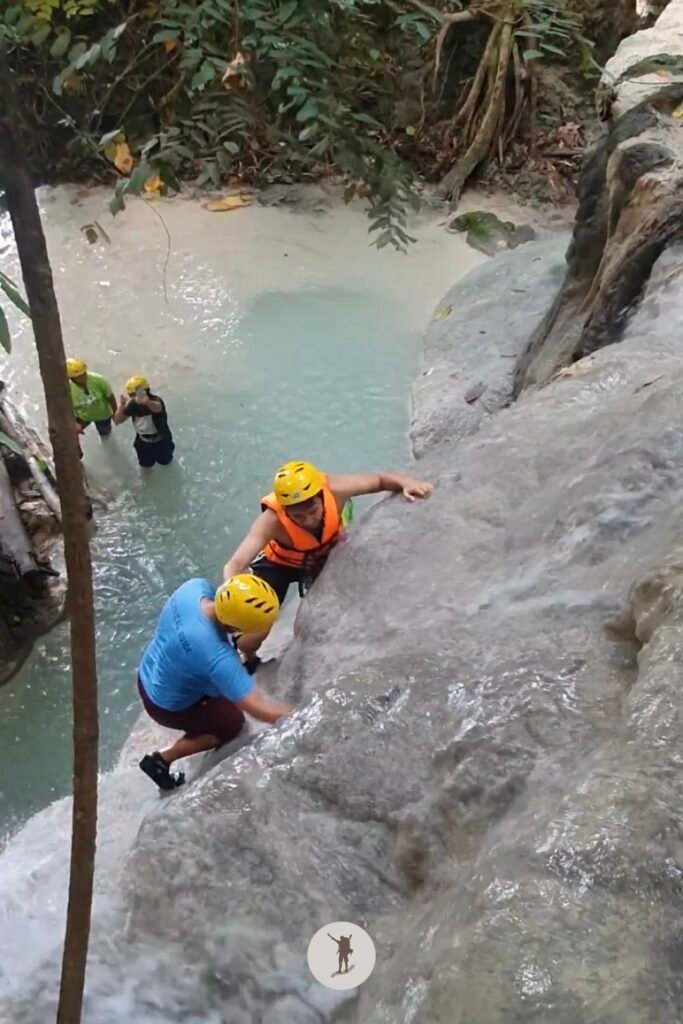 Part 2, a photo of me climbing a near-vertical rock formation at Aguinid Falls, Cebu, Philippines