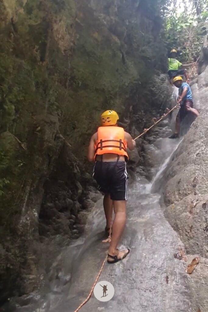 Part 2, a photo of me climbing to the top of the steep cascade at Aguinid Falls, Cebu, Philippines