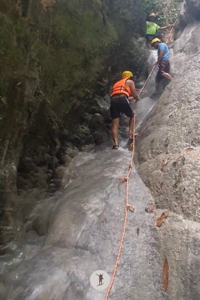 Part 3, a photo of me climbing to the top of the steep cascade at Aguinid Falls, Cebu, Philippines