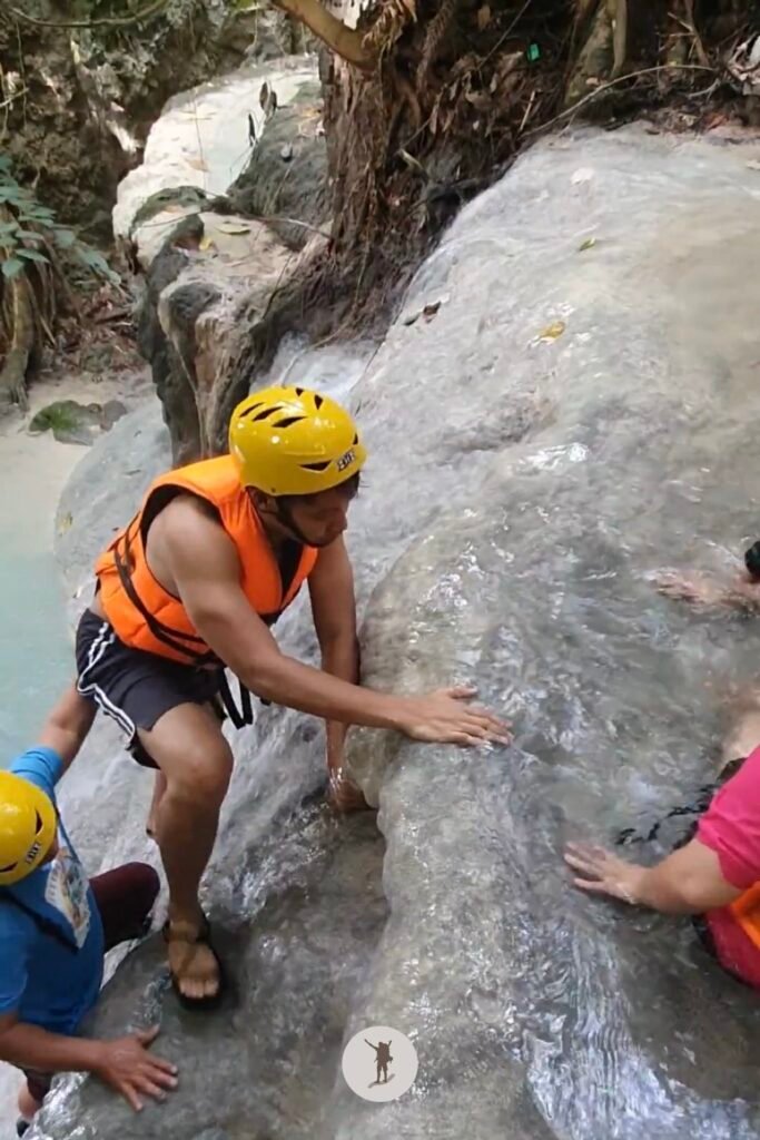 Part 4, a photo of me climbing a near-vertical rock formation at Aguinid Falls, Cebu, Philippines