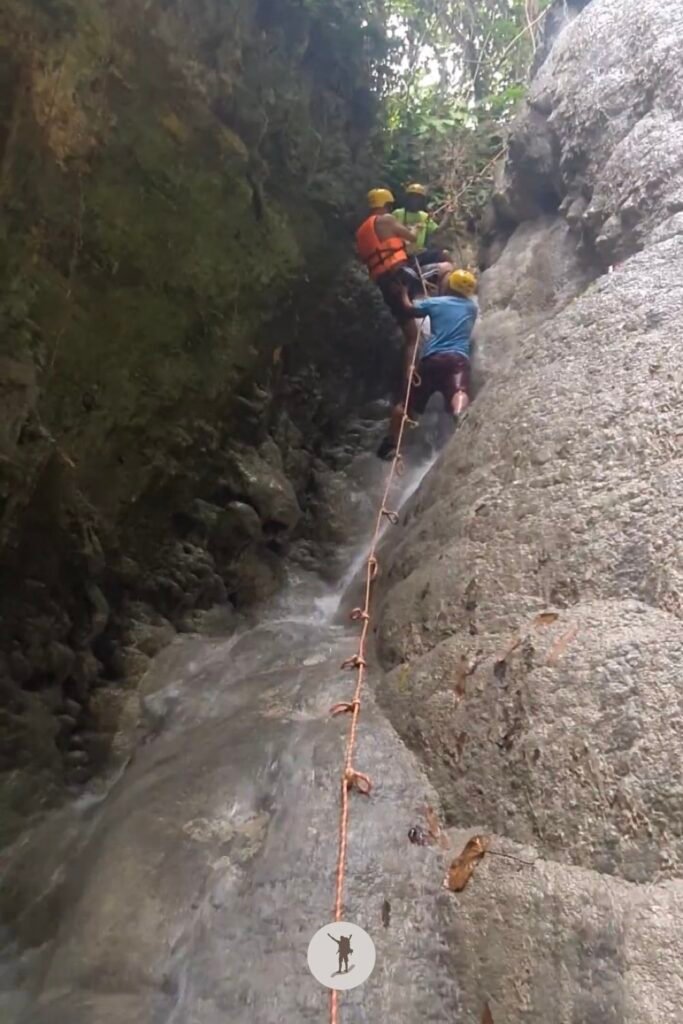 Part 4, a photo of me climbing to the top of the steep cascade at Aguinid Falls, Cebu, Philippines.