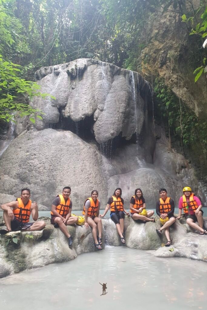 The mandatory souvenir shot of our travel group in front of the most iconic rock formation in Aguinid Falls, Cebu, Philippines