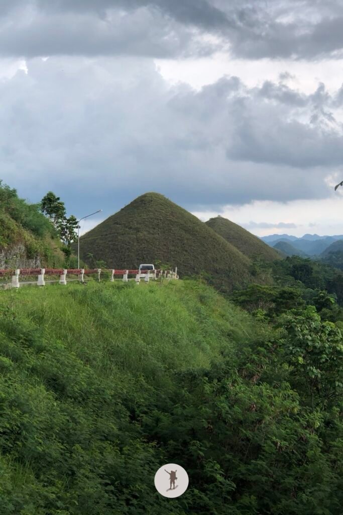 The road to the Chocolate Hills Complex with a view of a hill very close by, Bohol, Philippines